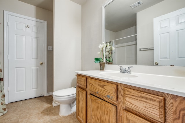 bathroom with tile patterned floors, vanity, and toilet