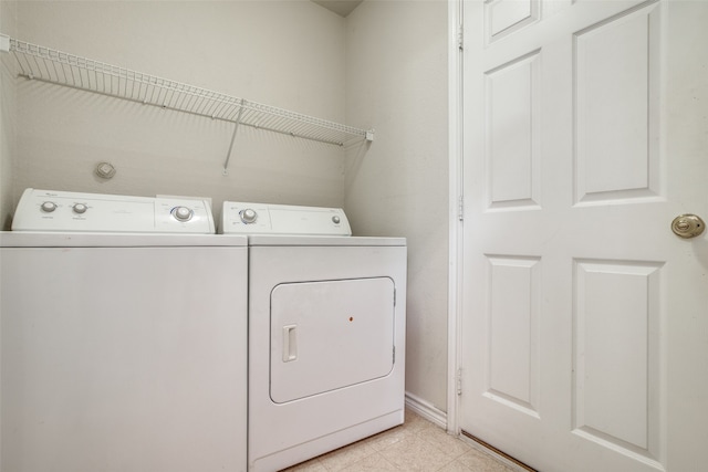 laundry area featuring separate washer and dryer and light tile patterned floors