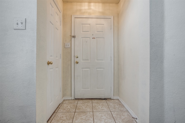 doorway featuring light tile patterned floors