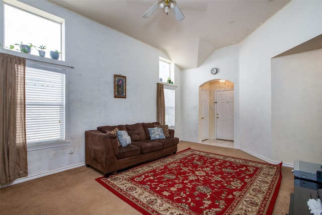 living room featuring high vaulted ceiling, ceiling fan, a healthy amount of sunlight, and light colored carpet