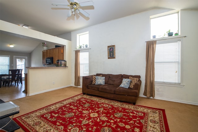 living room featuring ceiling fan, light colored carpet, and lofted ceiling