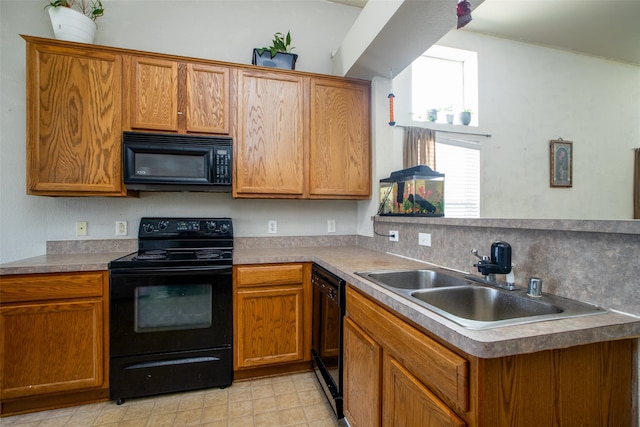 kitchen featuring sink, tasteful backsplash, light tile patterned floors, kitchen peninsula, and black appliances