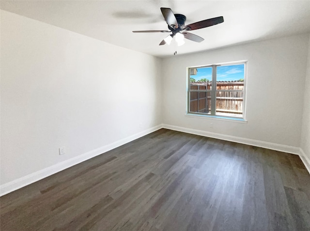 spare room with ceiling fan and dark wood-type flooring