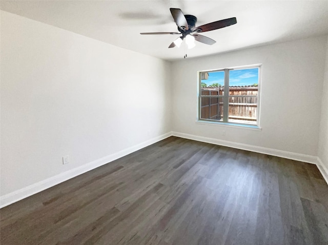 empty room with ceiling fan and dark wood-type flooring