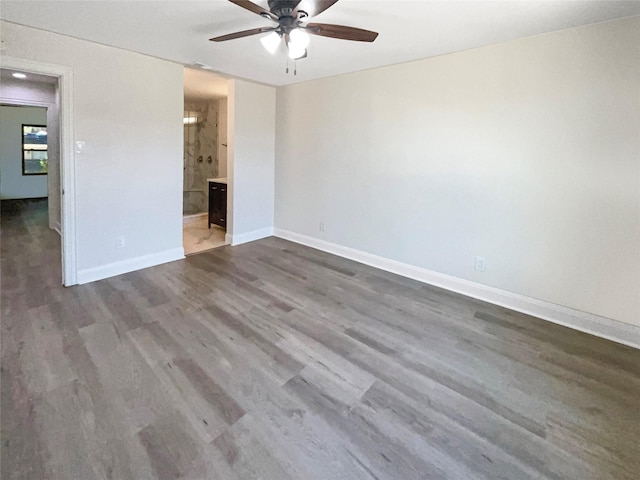 unfurnished bedroom with connected bathroom, ceiling fan, and dark hardwood / wood-style floors