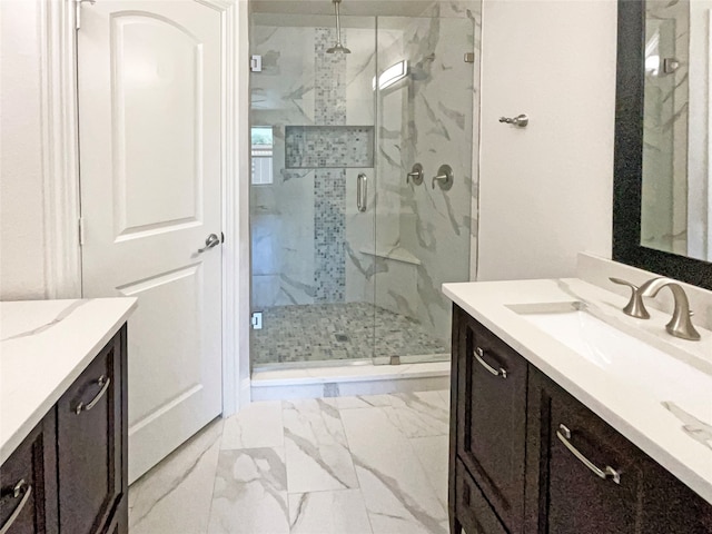 bathroom with a shower with door, vanity, and tile patterned floors