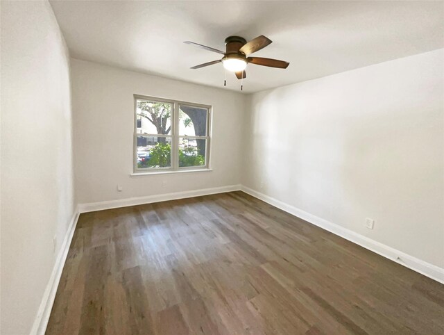 spare room featuring ceiling fan and dark hardwood / wood-style flooring