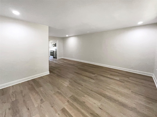 empty room with dark hardwood / wood-style floors