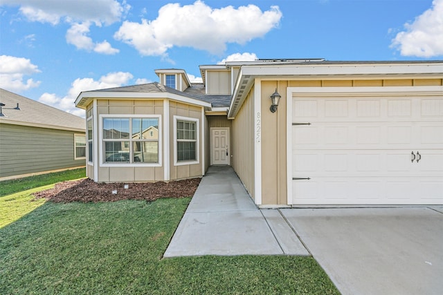 view of front of house with a garage and a front lawn