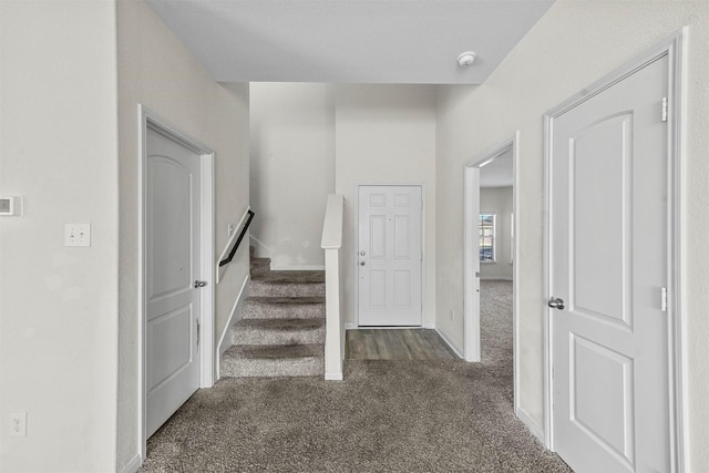 staircase featuring carpet and baseboards