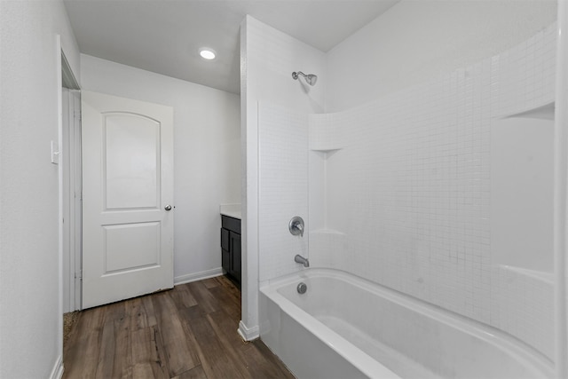 bathroom with vanity, bathing tub / shower combination, and hardwood / wood-style floors