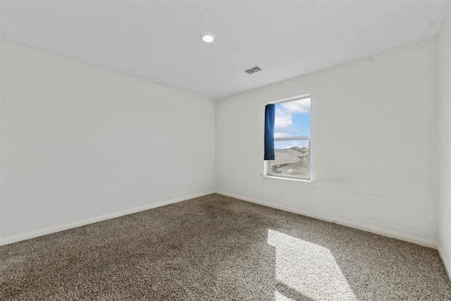 carpeted empty room with recessed lighting, visible vents, and baseboards
