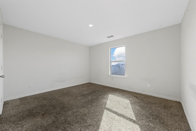spare room with recessed lighting, carpet floors, visible vents, and baseboards