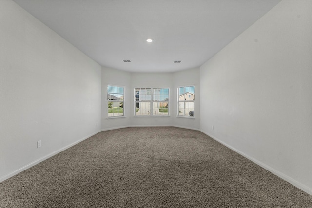 unfurnished room with carpet floors and baseboards
