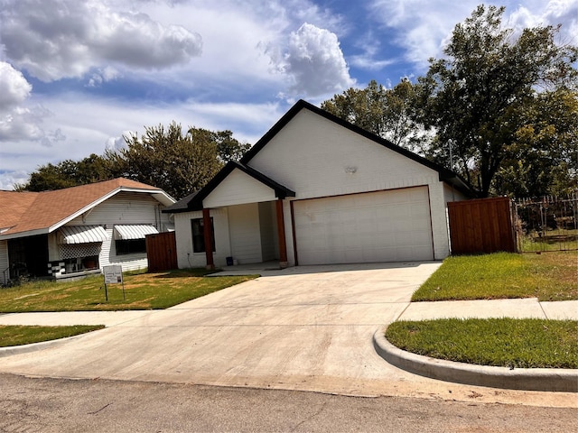 ranch-style home with a garage and a front yard