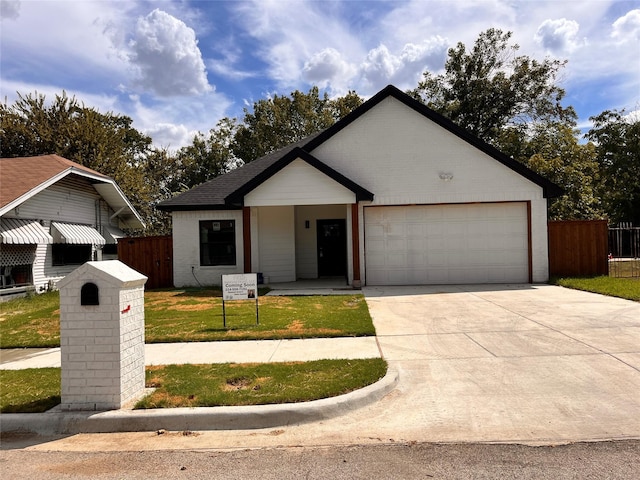 single story home with a garage and a front yard