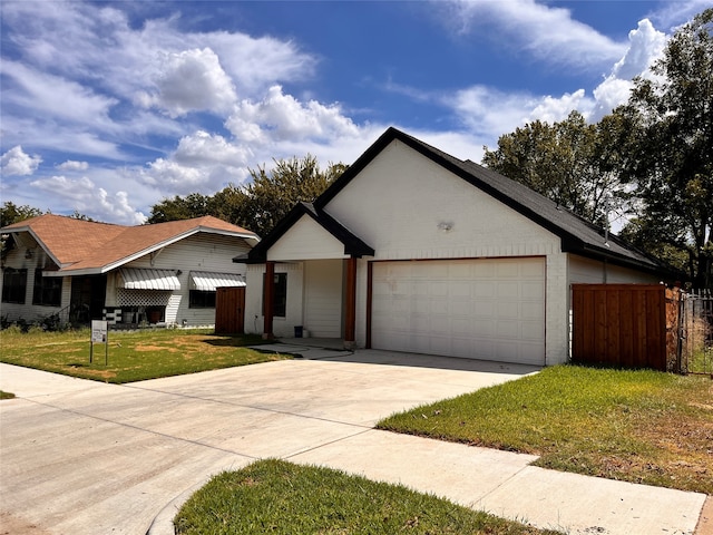 ranch-style home featuring a garage and a front lawn