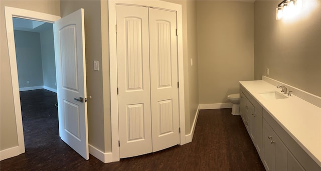 bathroom with vanity, hardwood / wood-style floors, and toilet