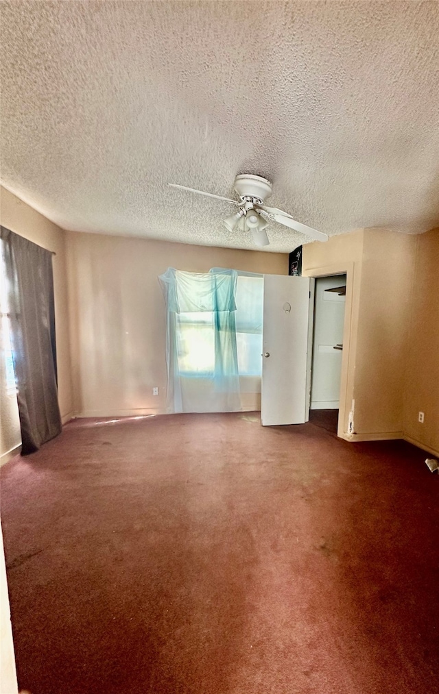 unfurnished room with ceiling fan, carpet floors, and a textured ceiling