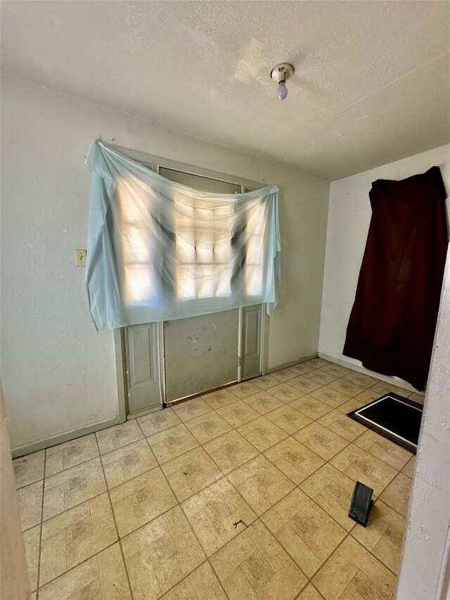 spare room with a textured ceiling