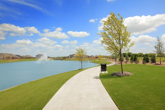 view of community featuring a water view and a lawn