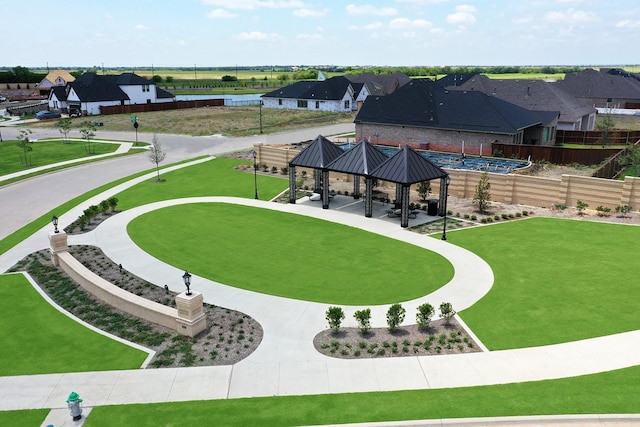 view of home's community featuring a residential view, fence, and a gazebo