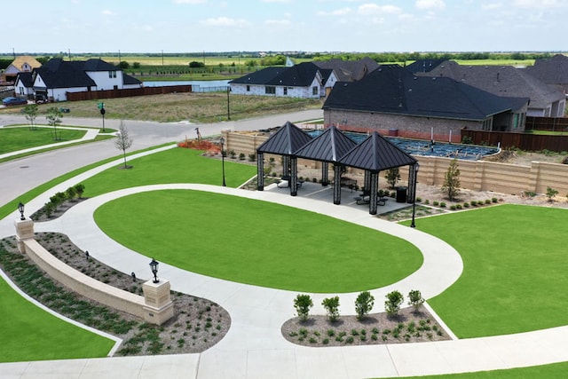 view of community featuring a gazebo, fence, and a residential view