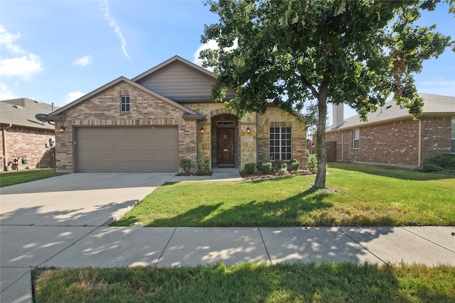 view of front of home featuring a garage and a front lawn