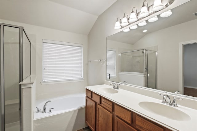 bathroom with vanity, separate shower and tub, and vaulted ceiling