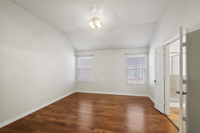 empty room featuring dark hardwood / wood-style floors and vaulted ceiling