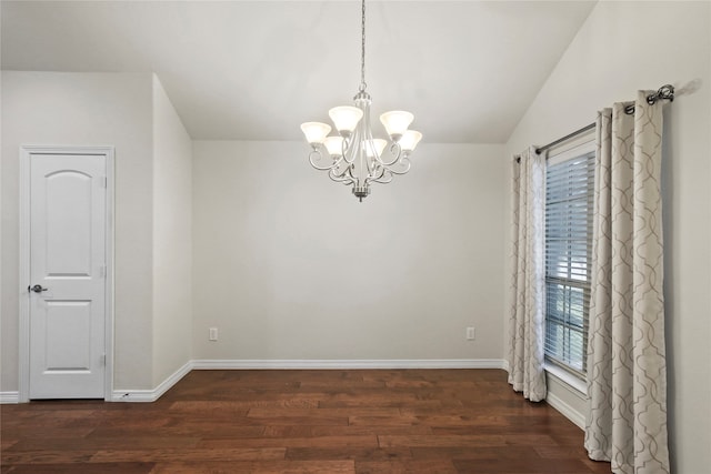 spare room featuring a notable chandelier, lofted ceiling, and dark hardwood / wood-style floors