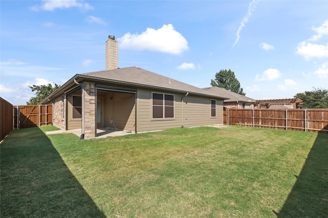 back of house featuring a patio area and a yard