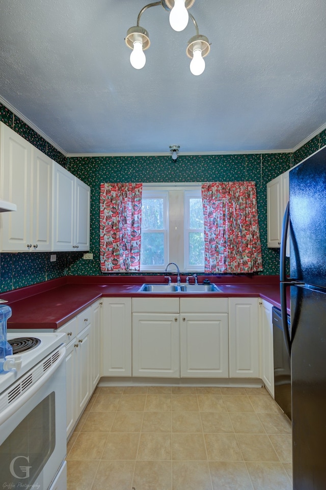 kitchen featuring light tile patterned flooring, sink, ornamental molding, dishwashing machine, and black refrigerator