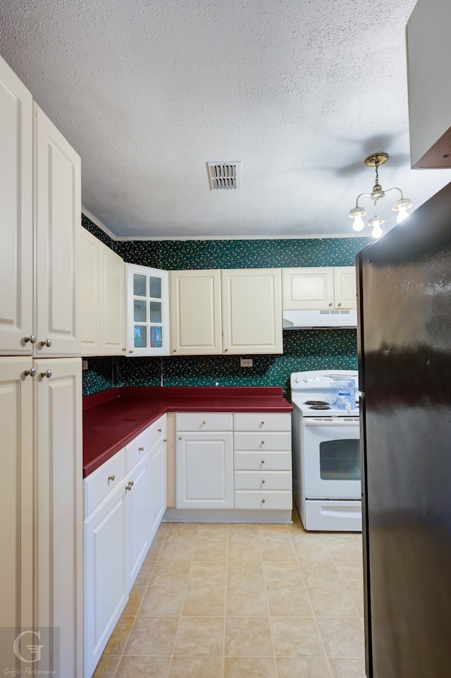 kitchen with backsplash, electric stove, light tile patterned floors, a textured ceiling, and black refrigerator