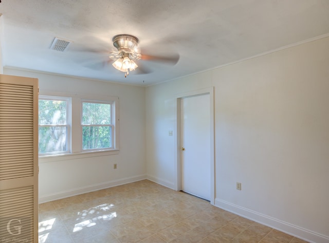 tiled spare room with ceiling fan