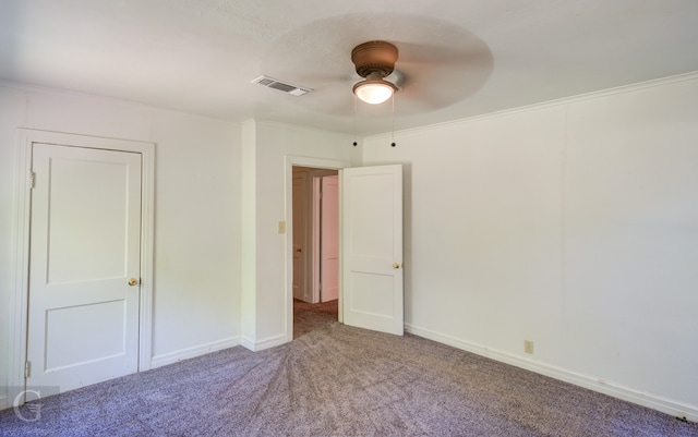 unfurnished bedroom featuring ceiling fan, carpet, and ornamental molding