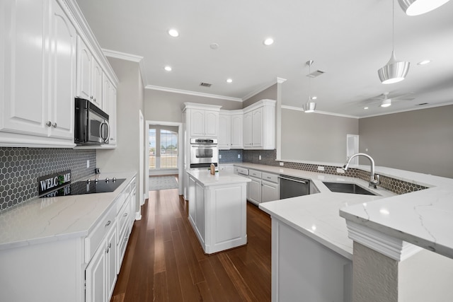 kitchen featuring backsplash, a kitchen island, stainless steel appliances, and kitchen peninsula