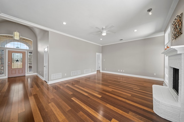 unfurnished living room with crown molding, ceiling fan, a brick fireplace, and hardwood / wood-style flooring