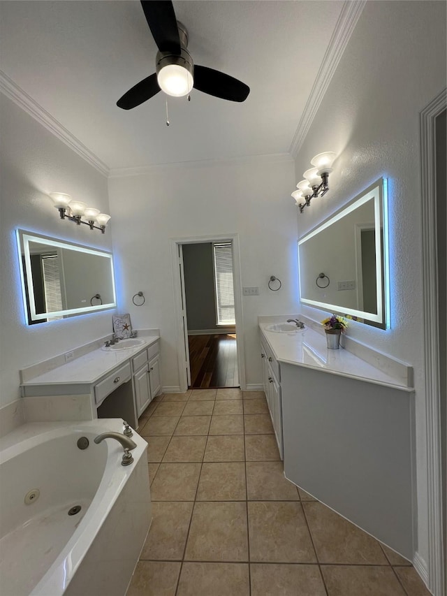 bathroom with a tub with jets, tile patterned flooring, vanity, and crown molding