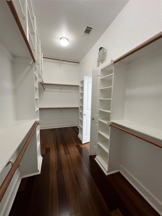 walk in closet with dark wood-style floors and visible vents