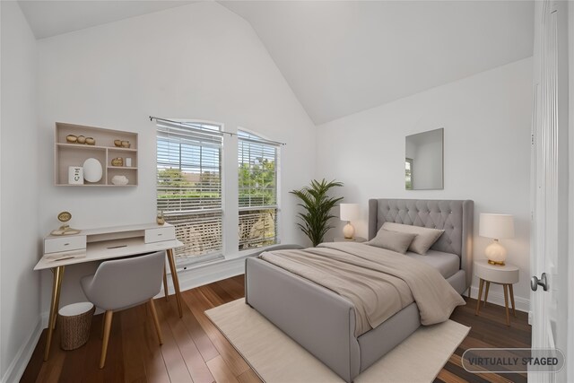 bedroom with dark hardwood / wood-style flooring and high vaulted ceiling