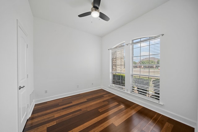 spare room with ceiling fan and dark hardwood / wood-style flooring