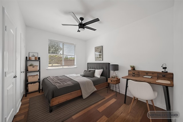 bedroom featuring ceiling fan, baseboards, and wood finished floors