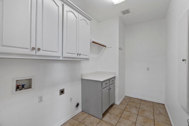 laundry area featuring hookup for a washing machine, light tile patterned floors, hookup for an electric dryer, and cabinets