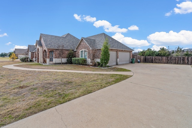 view of front of property with a front lawn and a garage