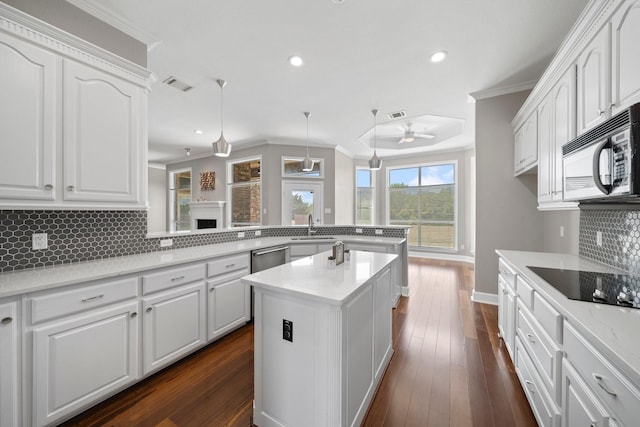 kitchen with visible vents, ornamental molding, a sink, a peninsula, and black appliances