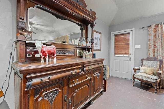 bar featuring lofted ceiling