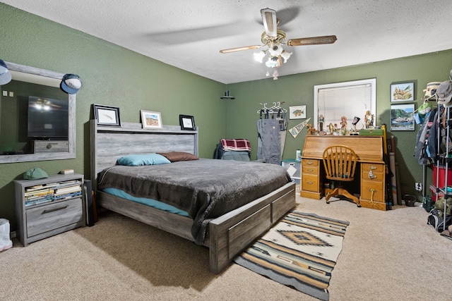 carpeted bedroom featuring a textured ceiling and ceiling fan