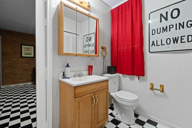 bathroom featuring tile patterned floors, vanity, and toilet