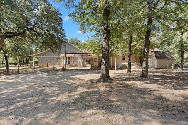 view of side of property featuring a storage shed